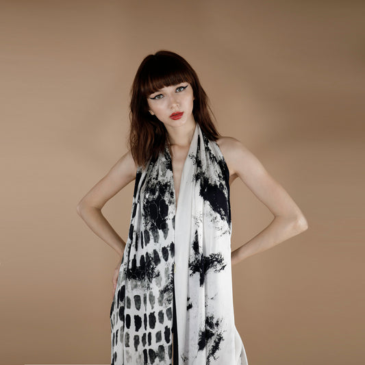 a black, grey and white printed scarf made from organic rose petal fabric. the print is inspired from botanical geometery.