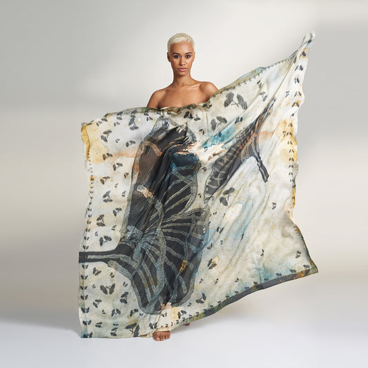  Sina Organic Aloe Vera Fabric Scarf, inspired by the timeless elegance of our Antique Reminiscence Collection. This exquisite scarf features hand-painted artwork depicting Royal Poinciana petals in various shapes and sizes, set against a sophisticated grey-gold background. 