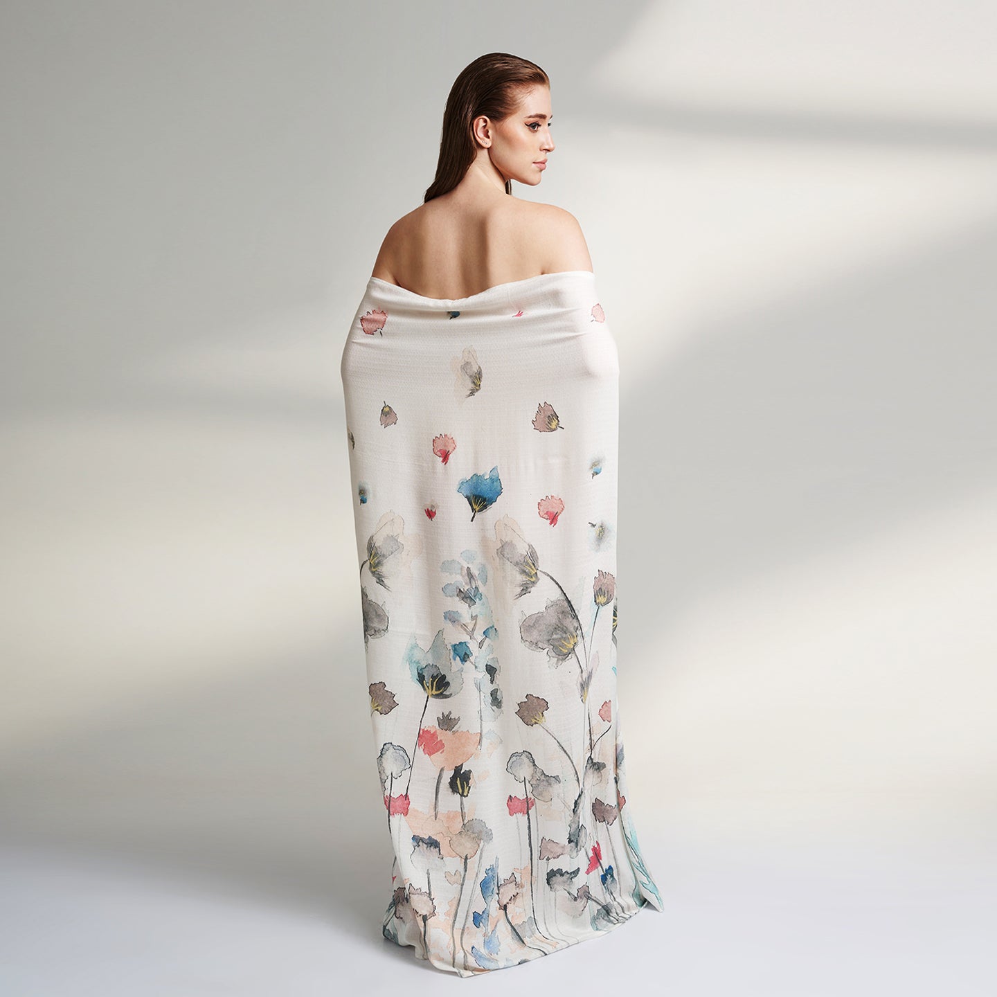A Square organic Aloe vera fabric scarf, printed on a white base with multicolor flowers and petals flying.