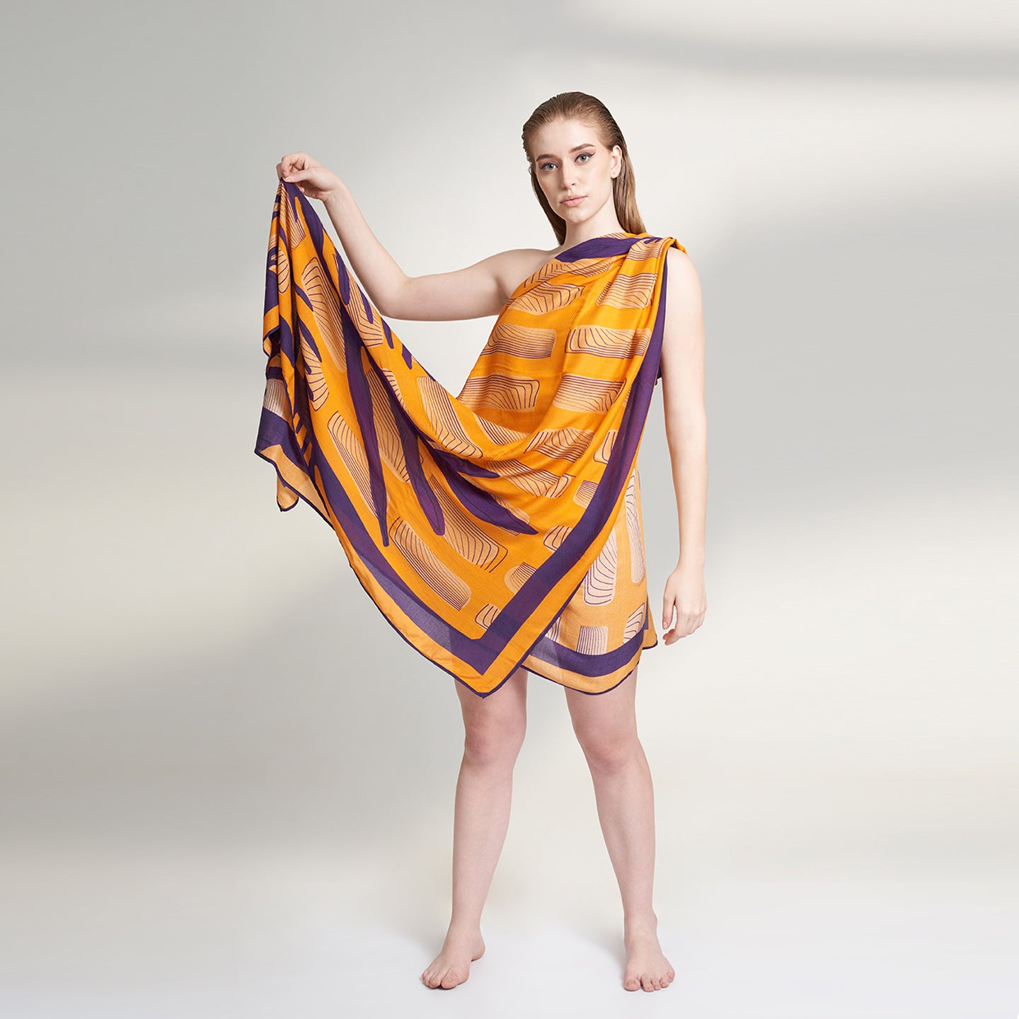 Amahle, a square scarf crafted from an organic Aloe Vera fabric, inspired by the intricate details of antique wall artworks adorned with climbing plant vines. This captivating scarf features a vibrant orange base adorned with elegant purple vine.