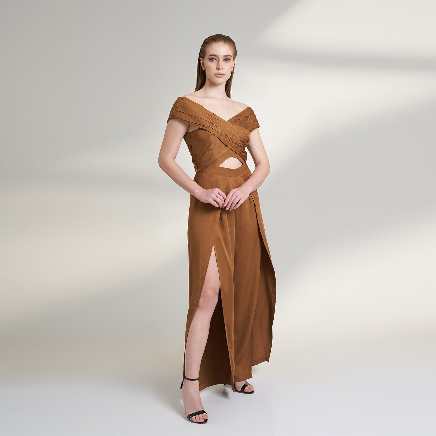 A brown tan color jumpsuit with wrap around ruched front bodice with overlap front slit pants.