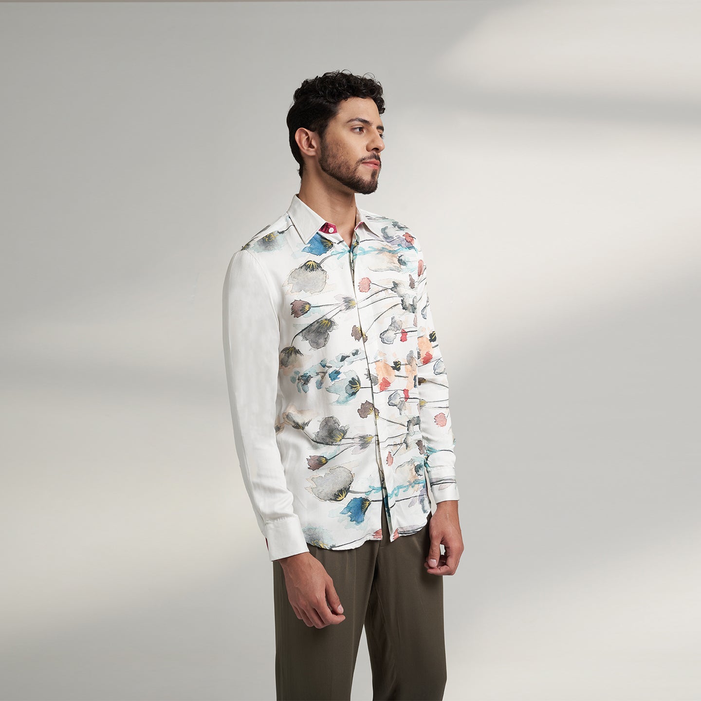 The printed WHITE floral organic lotus fabric shirt offers an interpretation of a timeless piece with a modern take. Made from a soft lotus stem silk fabric, It displays a comfortable fit and a rounded curved hemline featuring a placement floral pattern with one sleeve in solid and other sleeves in print, inspired by the  wilderness