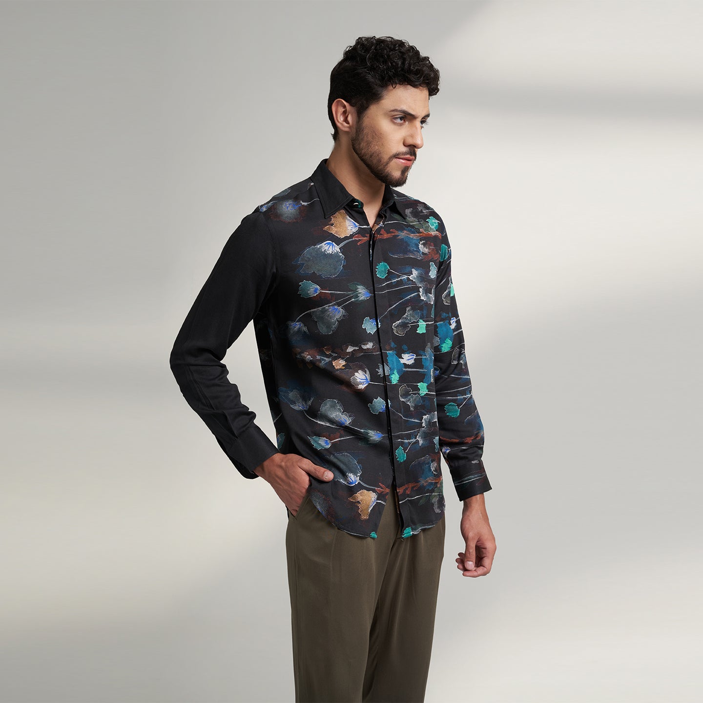The printed Black floral organic lotus fabric shirt offers an interpretation of a timeless piece with a modern take. Made from a soft lotus stem silk fabric, It displays a comfortable fit and a rounded curved hemline featuring a placement floral pattern with one sleeve in solid and other sleeves in print, inspired by the  wilderness