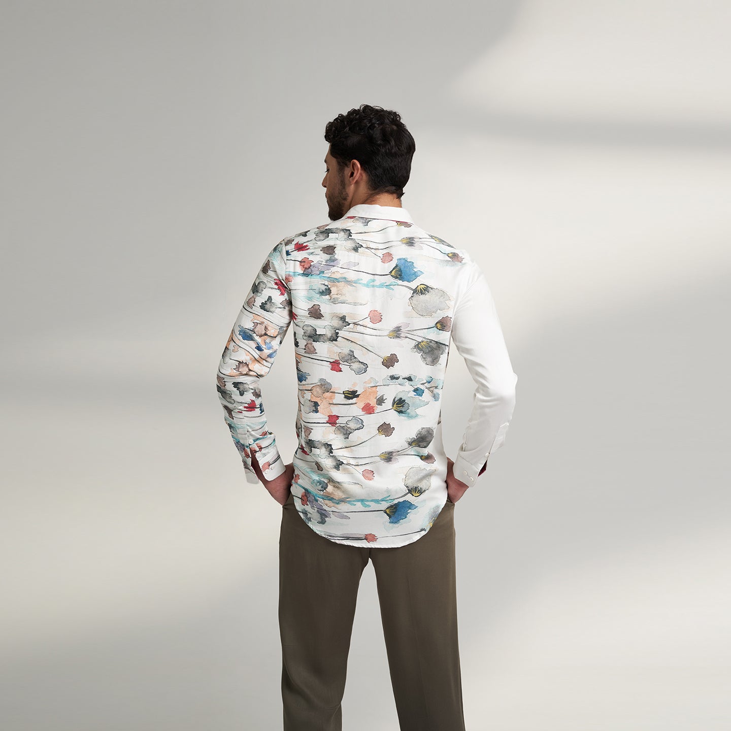 The printed WHITE floral organic lotus fabric shirt offers an interpretation of a timeless piece with a modern take. Made from a soft lotus stem silk fabric, It displays a comfortable fit and a rounded curved hemline featuring a placement floral pattern with one sleeve in solid and other sleeves in print, inspired by the  wilderness