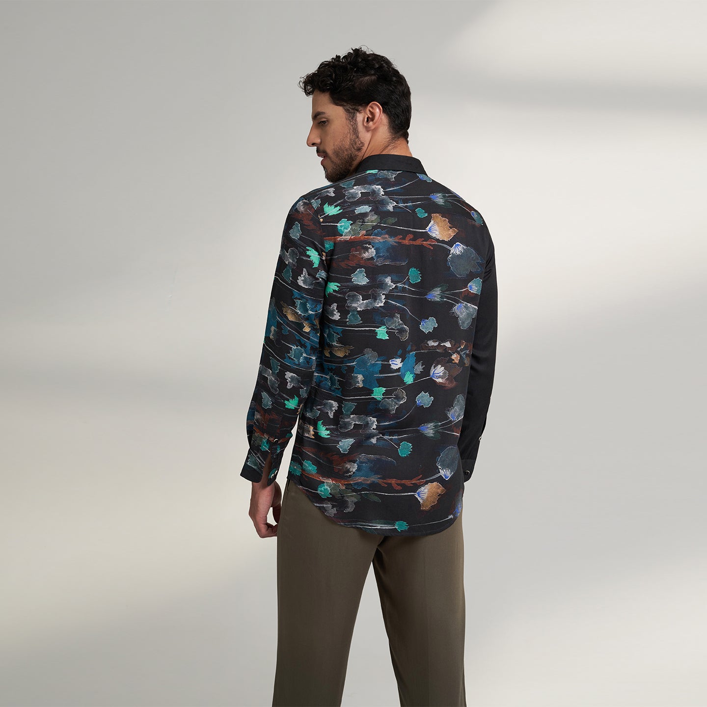 The printed Black floral organic lotus fabric shirt offers an interpretation of a timeless piece with a modern take. Made from a soft lotus stem silk fabric, It displays a comfortable fit and a rounded curved hemline featuring a placement floral pattern with one sleeve in solid and other sleeves in print, inspired by the  wilderness