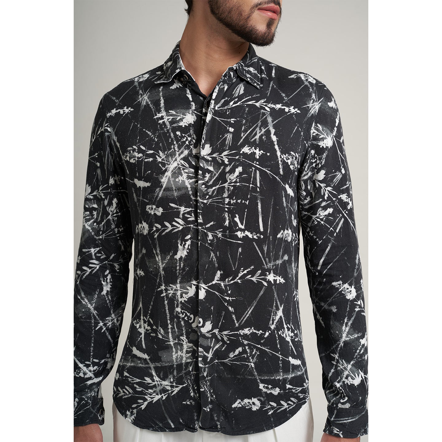 Organic lotus stem fabric printed shirt in black and white leafy print. the shirt has round bottom hem with a comfort fit